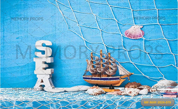 SHIP FISHING NET SEASHELLS STARFISH AND CHEST ON SAND PRINTED BACKDROP